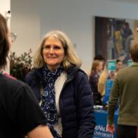 Interim Dean Mark Schaub and Associate Dean Karen Gipson talk to a student about her poster presentation